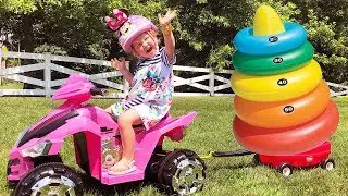Avery playing with giant colored stacking rings for kids