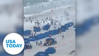 Cameras capture waterspout ripping through crowded beach | USA TODAY