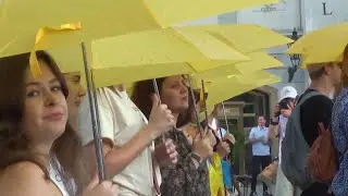 Prague demonstrators use umbrellas to urge global action for Ukraine’s defense