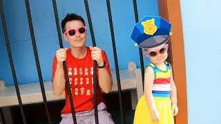 Avery pretend play as a cop and locked up parents in jail playhouse in amusement park for kids