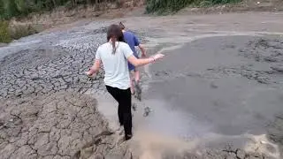 Girls & Boys playing in the mud barefoot