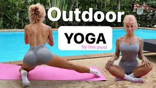 Outdoor relaxing yoga by the pool