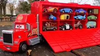 Find a Disney Cars miniature car and put it on the trailer