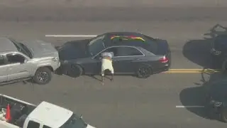 Suspect struggles to surrender, gets stuck climbing out of car following police chase