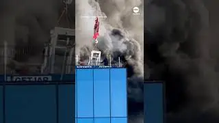 Man rescued from roof of burning high-rise by crane - ABC News