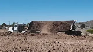 Side and bottom Dump Truck trailers in action moving desert soil in Arizona, Truck Spotting USA