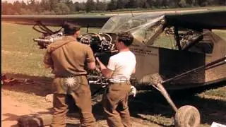 U.S. Army aircraft mechanics repair a Stinson L-5 airplane in Germany HD Stock Footage